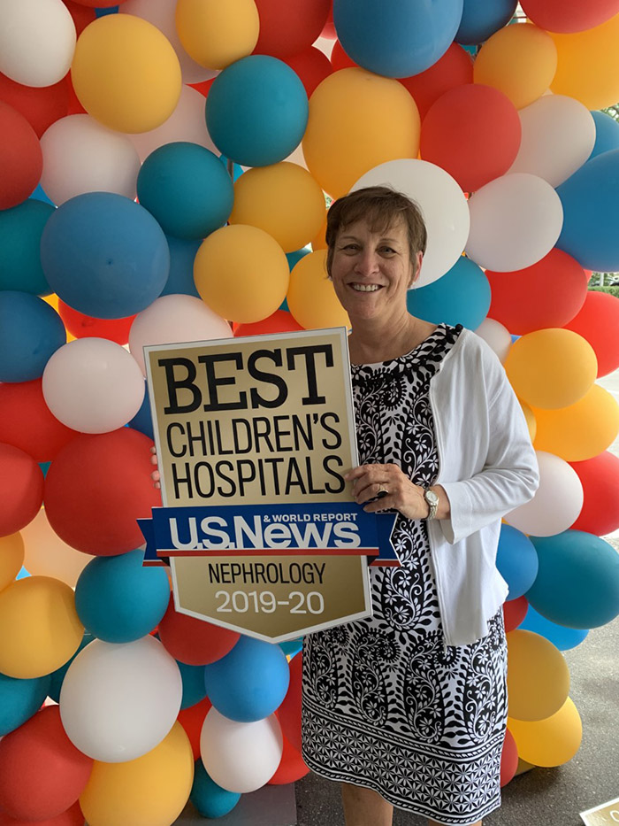 Dr. Susan F. Massengill holding best children’s hospital by U.S. News & World Report